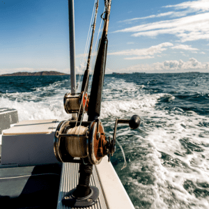 Fishing reels mounted on boat, ocean in background